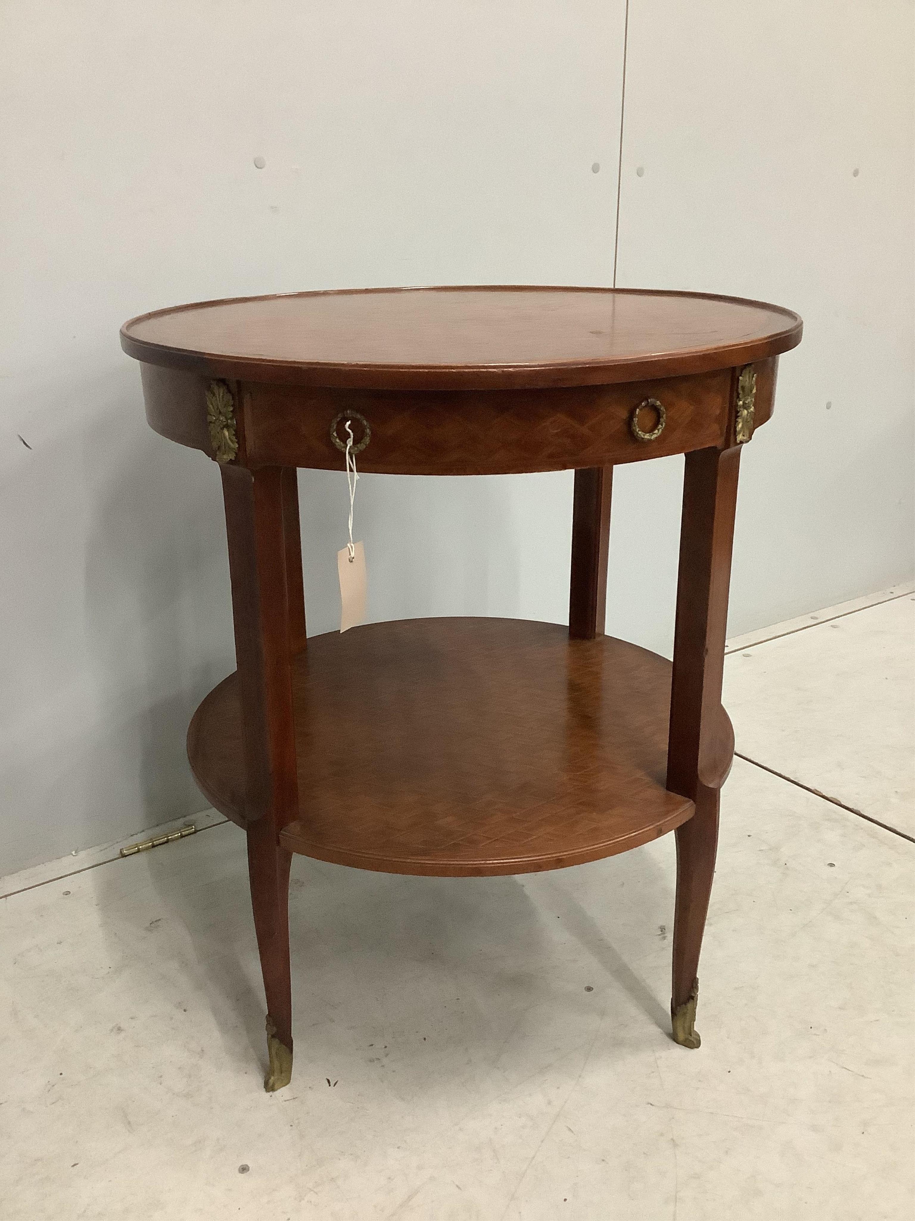 A French transitional style gilt metal mounted circular two tier occasional table, diameter 66cm, height 75cm. Condition - fair